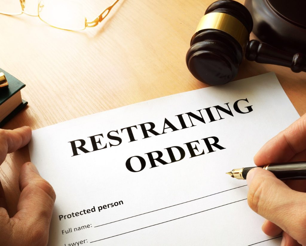 What is a Temporary Restraining Order (TRO) and how does it differ from an Order of Protection?